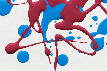 Attractive bright abstract background: drops and spills of nail polish in blue and wine colors