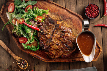 Top view on grilled beef ribeye steak with pepper sauce