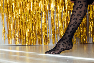beautiful slender women's legs in black tights