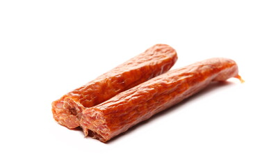 Broken smoked sausages isolated on white background