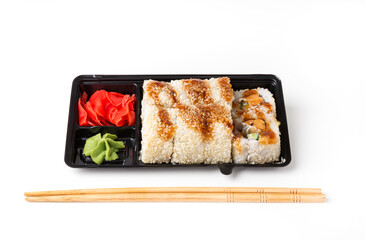 Rolls in black plastic box, japanese food as fast food, isolated on white.