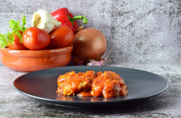 Codfish with tomato sauce, garlic and parsley.