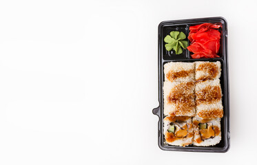 Rolls in black plastic box, japanese food as fast food, isolated on white.