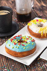Delicious donuts decorated with different decorations on wooden table