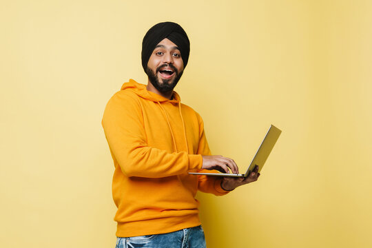 Bearded South Asian Man Wearing Turban Using Laptop