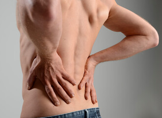 Mid adult man suffering from stomach ache, close up