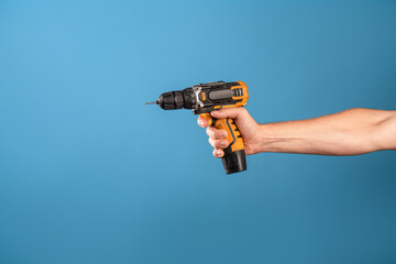 Fix it, fix a malfunction or tighten a bolt on a construction site. A man's hand holds a...