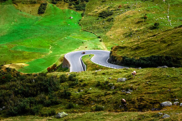 Motorcyclist on the Furka Pass. This 2431 meter high mountain pass in Switzerland connects the...