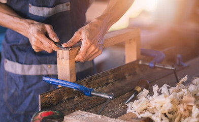 Carpenter working with equipment on wooden table in carpentry shop. men works in a carpentry shop.
