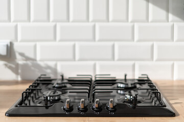 Black stove in modern kitchen interior in white colors