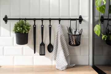 Modern kitchen cutlery hanging on white wall