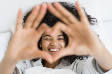 Afro american woman showing heart shape with hands