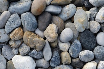 Fototapeta na wymiar grey pebble stones closeup nature background