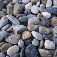 Fototapeta na wymiar grey pebble stones closeup nature background