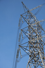 High voltage pole against clear blue sky background