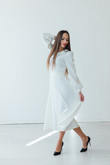 brunette women with blue eyes in a white summer dress