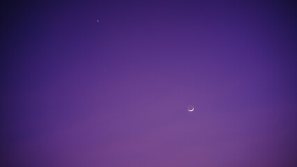 the view of the sky at night saw a crescent moon and stars.