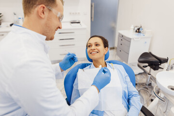 Dental doctor treating female patient teeth