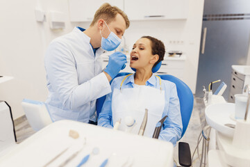Obraz premium Woman having teeth examination by young dentist