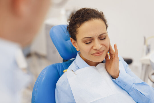 Sad woman feeling paint in teeth