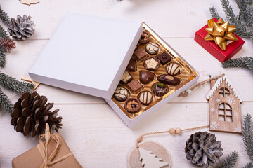 christmas chocolate candy box on a wooden table with seasonal holiday decoration