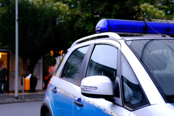 close-up of typical police vehicle in germany with blue flashers in city, used by police to patrol...