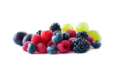 Ripe berries and fruits isolated on white background. Juicy and delicious raspberries, blueberries, blackberries and grapes. Mixed berries with copy space for text.