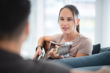woman are happy and fun to playing guitar music instrument at home