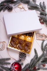 christmas chocolate candy box on a wooden table with seasonal holiday decoration