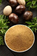 Obraz na płótnie Canvas Bowl of organic nutmeg powder, Indian cooking masala spices. 