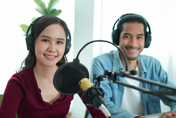 content creator occupation concept. Two influencer record podcast audio in-home office by a...