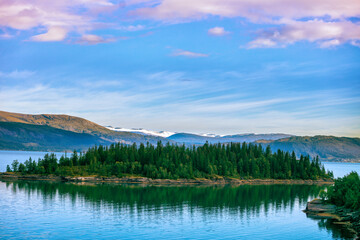 Rocky shore of a mountain lake in the autumn morning. Beautiful nature of Norway