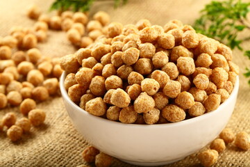 Bowl of uncooked soya chunks, vegan cooking ingredients.