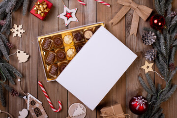 christmas chocolate candy box on a wooden table with seasonal holiday decoration