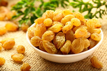 Bowl of sundried delicious organic yellow dry grapes. 