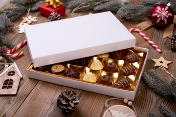 christmas chocolate candy box on a wooden table with seasonal holiday decoration