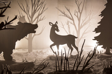 White illuminated animals and trees cut from veneer - Christmas decor at night, Kuldiga, Latvia