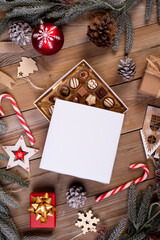 christmas chocolate candy box on a wooden table with seasonal holiday decoration