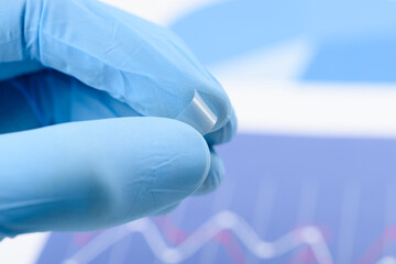 Scientist bend flexible transparent plastic like thin film material in laboratory. Concept of...