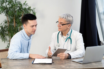 Consultation doctor age man portrait with glasses positive and patient