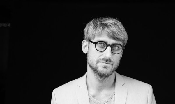 Bearded man staring on black background