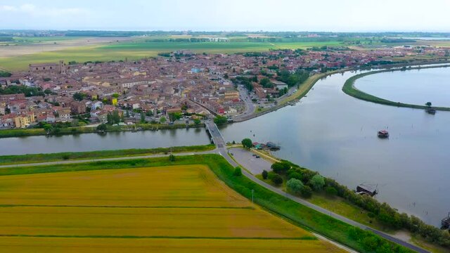 aerial 4k view of comacchio city, emilia romagna, italy, venice lagoon, fishermen city, city above water with bridges 
