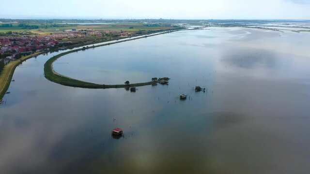 aerial 4k view of comacchio city, emilia romagna, italy, venice lagoon, fishermen city, city above water with bridges 
