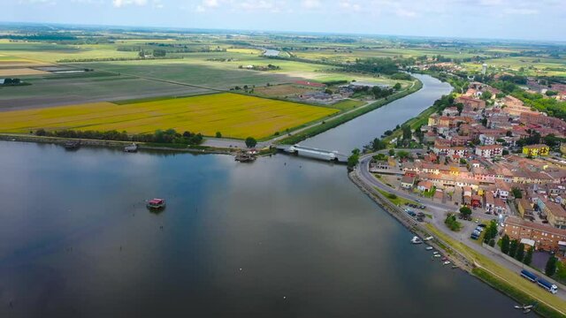 aerial 4k view of comacchio city, emilia romagna, italy, venice lagoon, fishermen city, city above water with bridges 