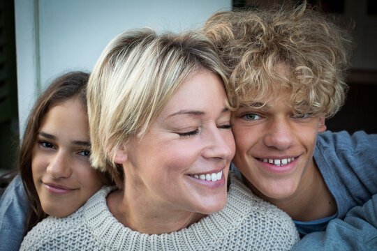 Portrait of smiling son and daughter with mother