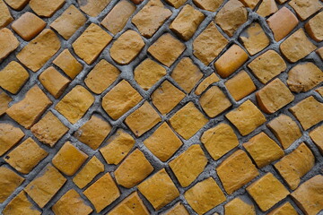 Vibrant orange mosaic wall texture (front view)
