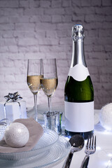 wine champagne bottle on a christmas party holiday table with empty label copy space