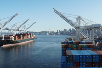 Container SSA terminal with gantry cranes on both sides. There is a container merchant vessel being...