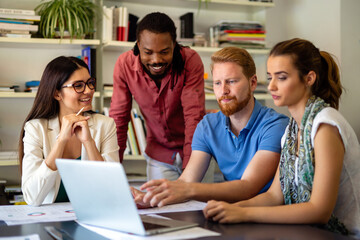 Group of happy business people discussing and working together during a meeting in office