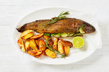 baked trout fish with roast potatoes, top view